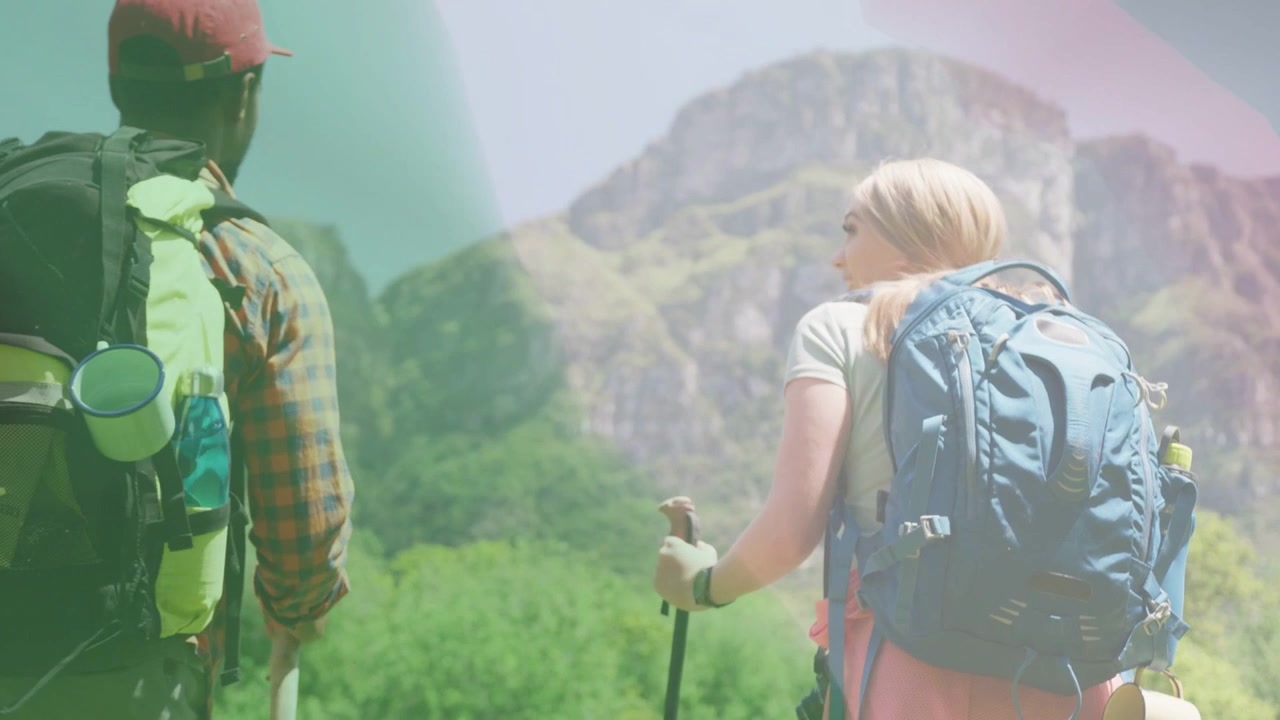 Hiking partners walking outdoor valley trail, camera pulling back, color leaks showing route plan