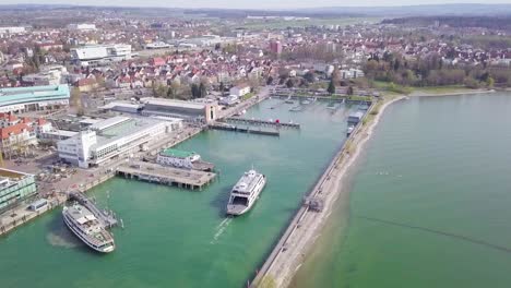 aerial shot of ferry arriving at port in friedrichshafen