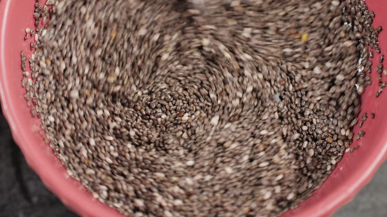 Chia seeds close-up macro. Dry healthy ingredient. Healthy superfood rich in Omega 3 fatty acids. Salvia hispanica. High quality 4k footage