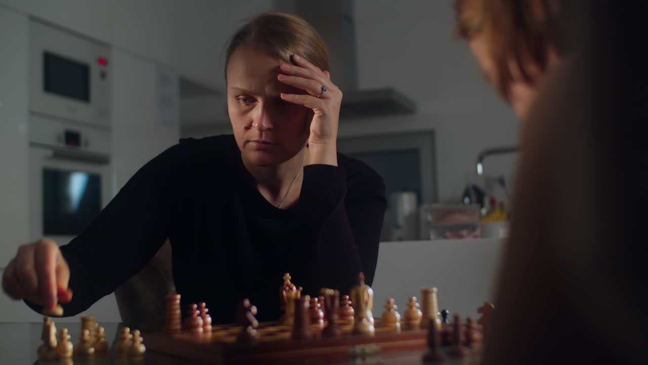Mother and Her Son Compete in a Game of Chess