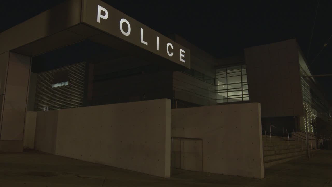 Police station logo and sign lit up at night