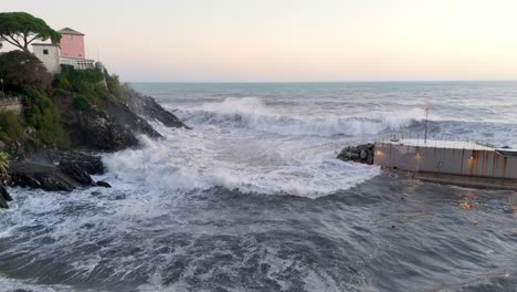 Big-foamy-sea-waves-crashing-into-narrow-harbor-between-cliff-and-pier