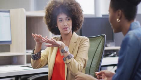 Video-of-happy-diverse-businesswomen-talking-about-project