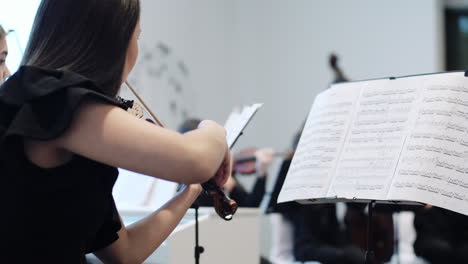 violinist playing in orchestra