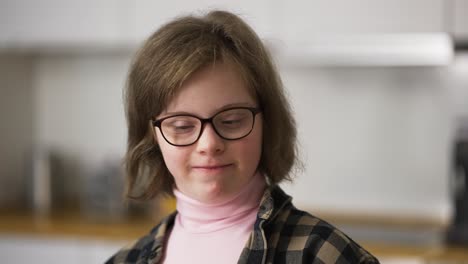 Cheerful-kid-smiling-at-camera-at-home.-A-person-with-special-needs