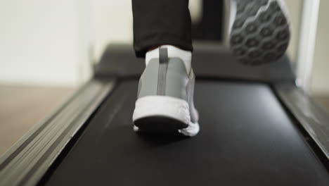 close up of man's foot running on a treadmill