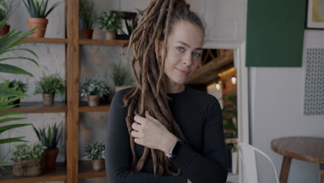 woman with dreadlocks in a cozy cafe