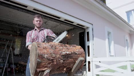 man using chainsaw to cut a log outside