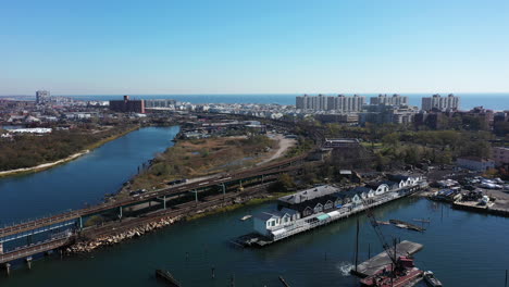 an aerial drone shot over grassy bay in a neighborhood of queens, ny