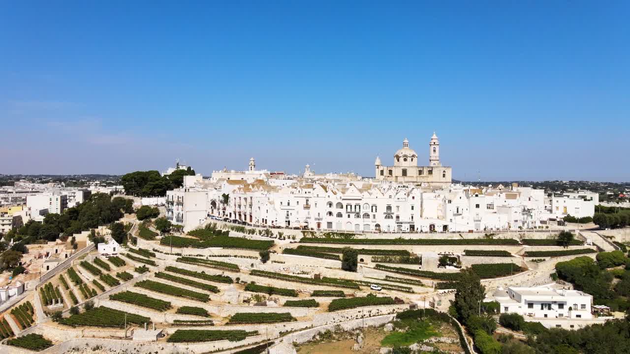 Aerial landscape view of Locorotondo village houses, traditional italian hilltop town, on a sunny day