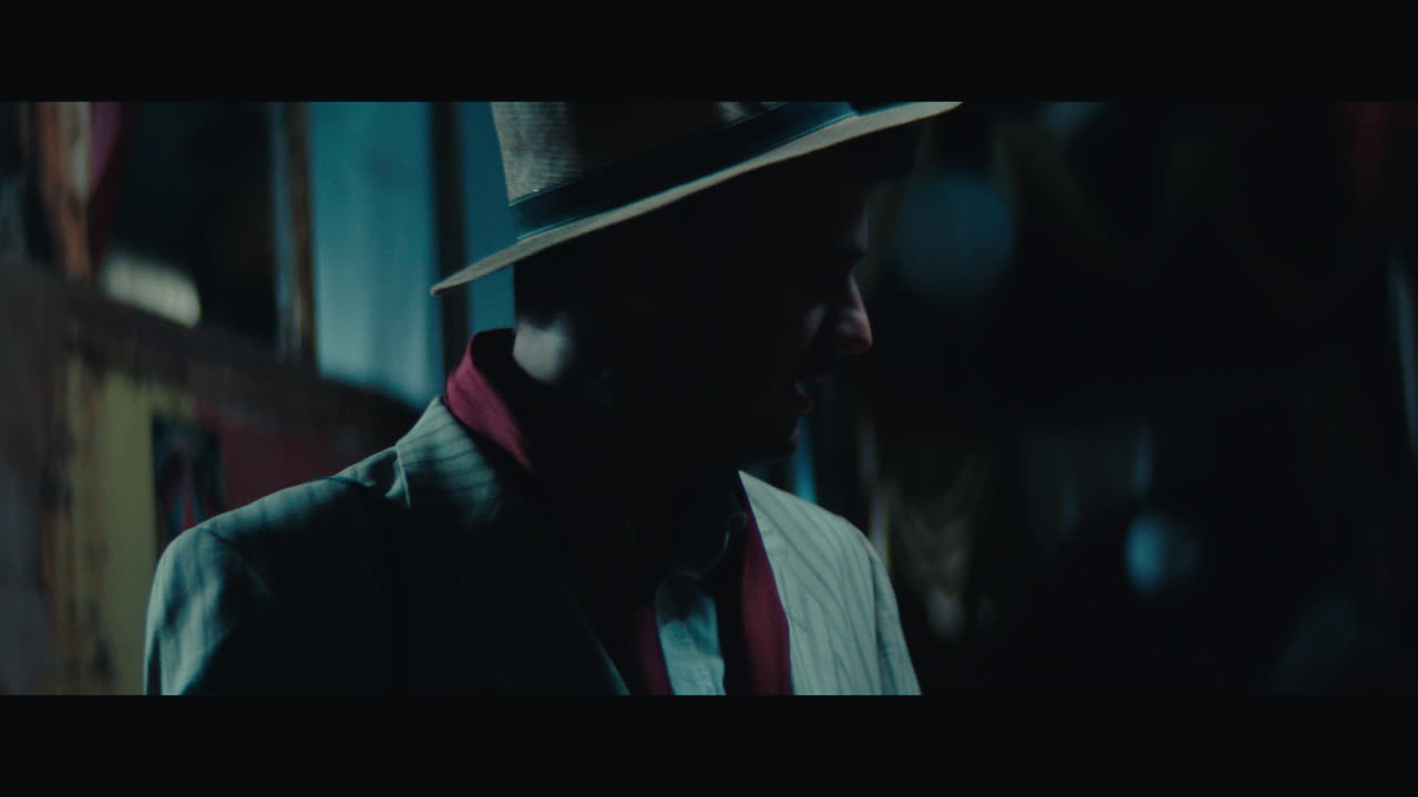A man in hat in the empty gypsy circus camp at night