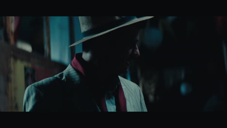 a man in hat in the empty gypsy circus camp at night