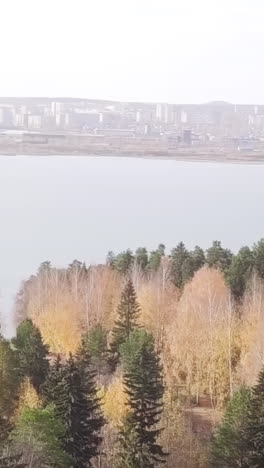 autumn landscape with city and river