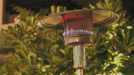 blue flames on gas patio heater outside on terrace