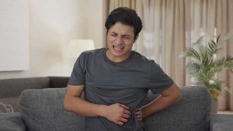 Sick-Indian-man-suffering-from-back-pain