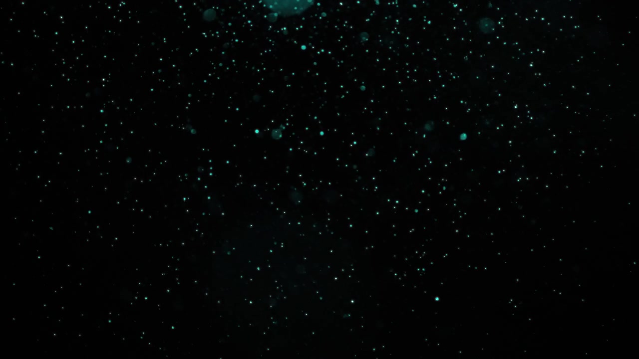 Particules turquoises tombant lentement