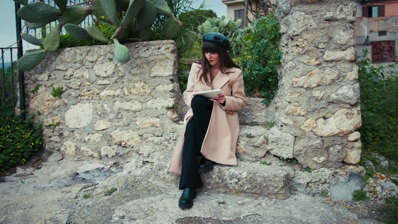Vintage Dressed Woman Relaxing And Drawing In The Small Italian Hamlet