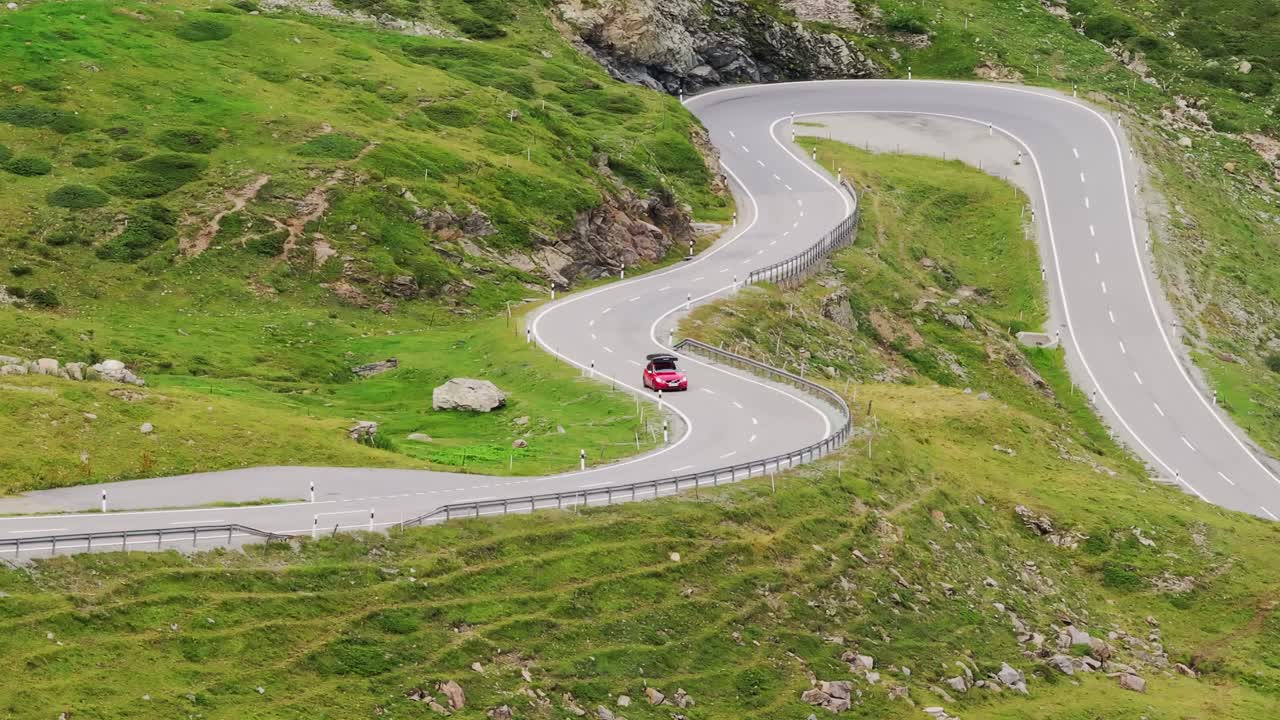 Drone of curving Swiss mountain road, Lago Bianco region at Passo del Bernina