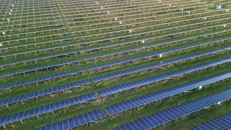 shotton solar farm panels, aerial drone fly overhead and gimbal down - north wales, uk