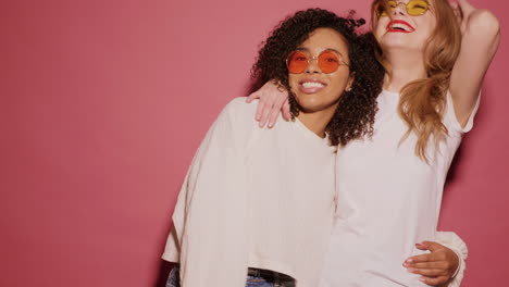 two women friends embracing with sunglasses