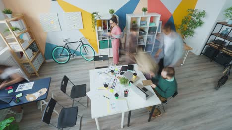 high angle view time-lapse of young people colleagues working in open space office