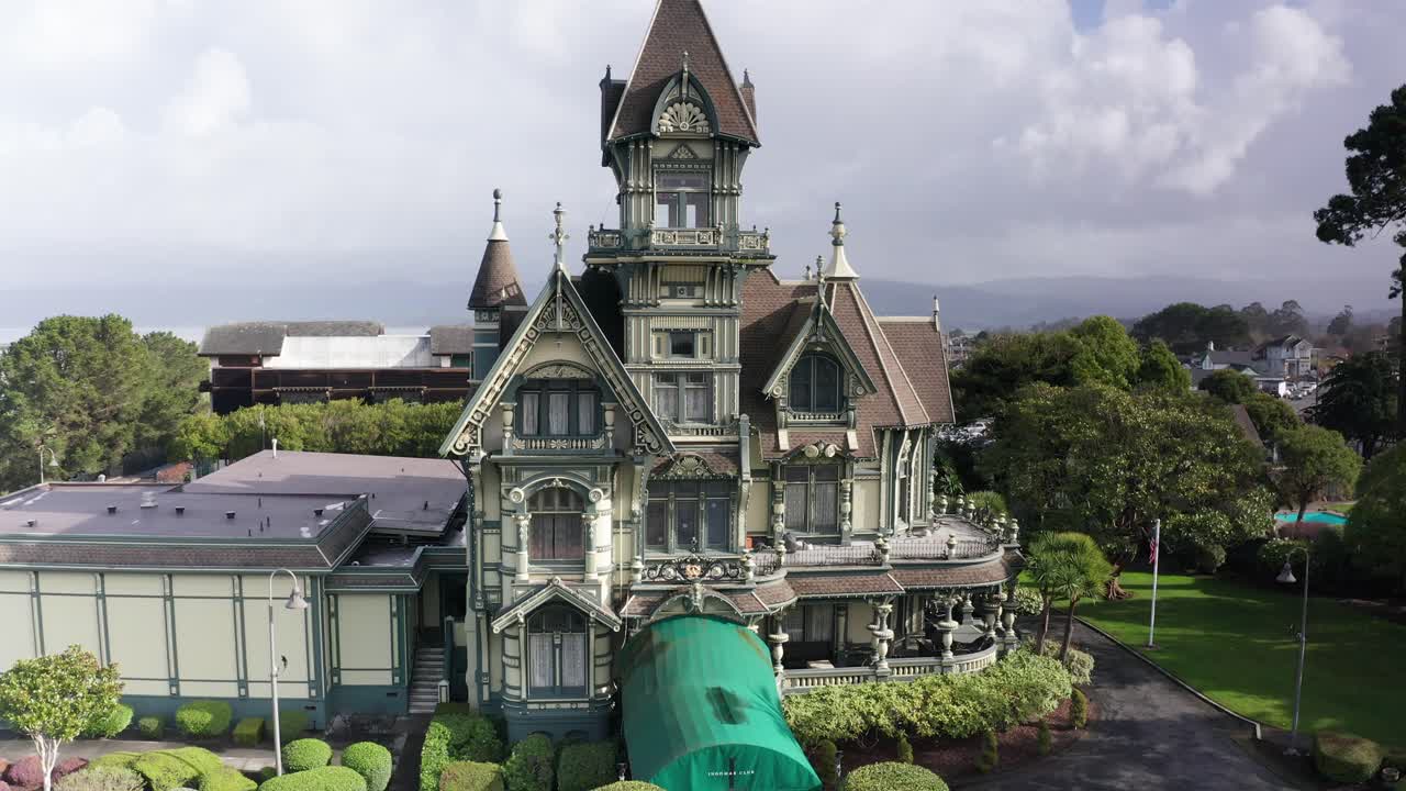 Aerial panning close-up shot of the historic Carson Mansion, a well-preserved Victorian mansion in old town Eureka, California. 4K