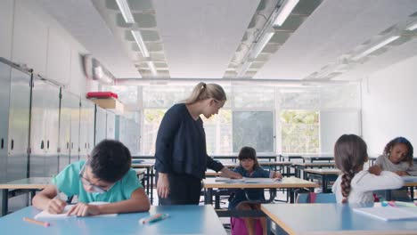 female school teacher walking between desks