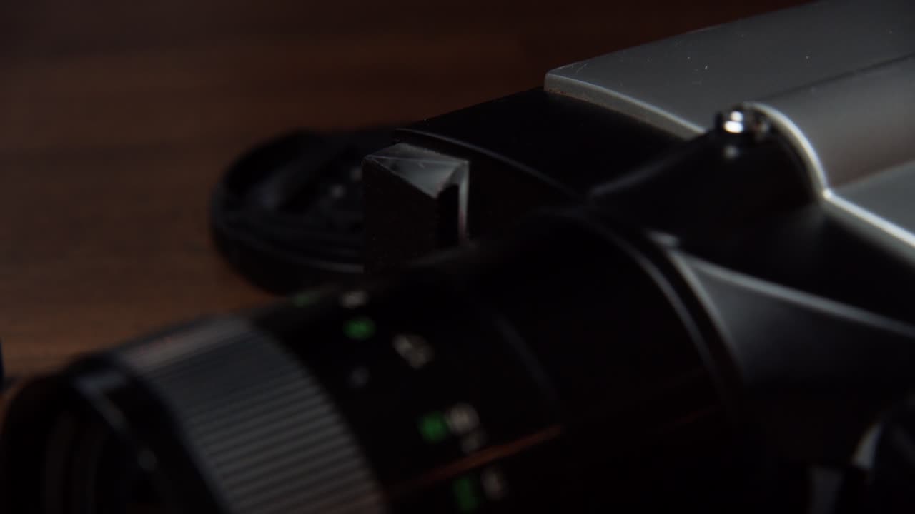 The zoom of a camera placed on a table, close shot, slow motion