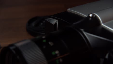 the zoom of a camera placed on a table, close shot, slow motion
