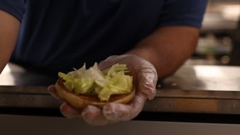 empleados de comida rápida haciendo hamburguesas
