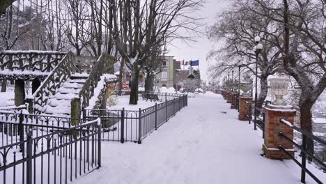 snow falling in the garden of villa comunale, guardiagrele, abruzzo, italy