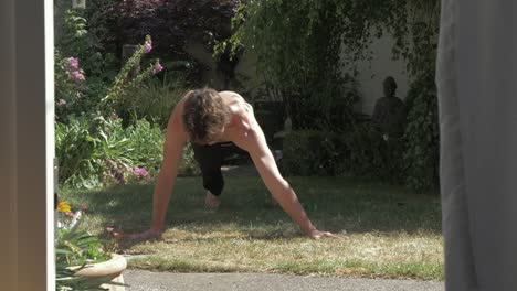 Un-Joven-En-Forma-Haciendo-Flexiones-De-Arquero-En-El-Sol-Del-Patio-Trasero