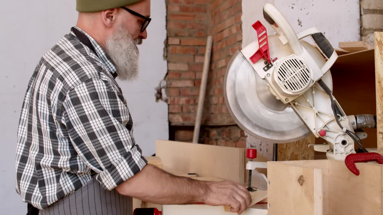 Carpenter Working with Electrical Circular Saw