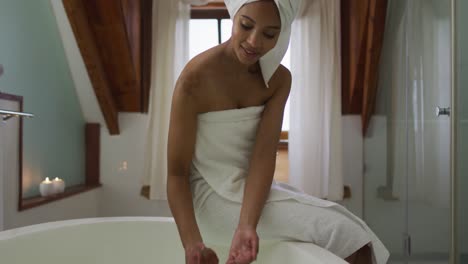 mixed race woman running a bath