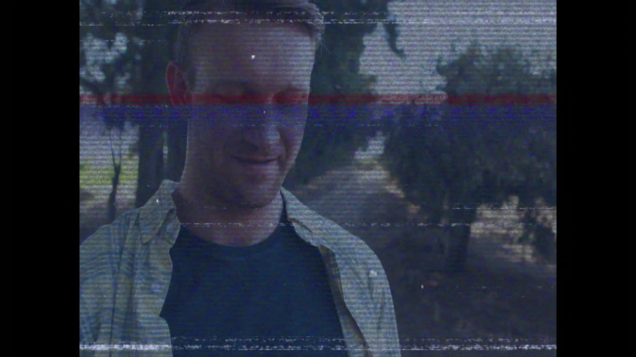 Standing outdoors, man with animation digital glitch effect overlaying scene