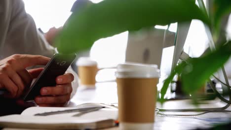 male executive using mobile phone at desk 4k