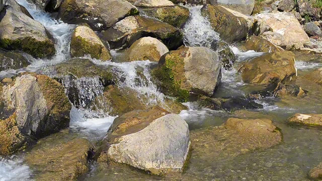 Water cascades over rocks and stones in the river at Weesen, Glarus, Switzerland, highlighting nature's beauty