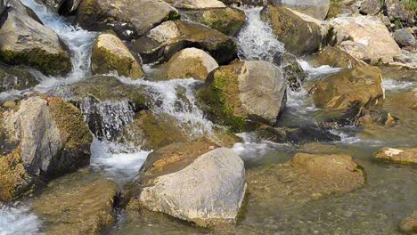 water cascades over rocks and stones in the river at weesen, glarus, switzerland, highlighting nature's beauty