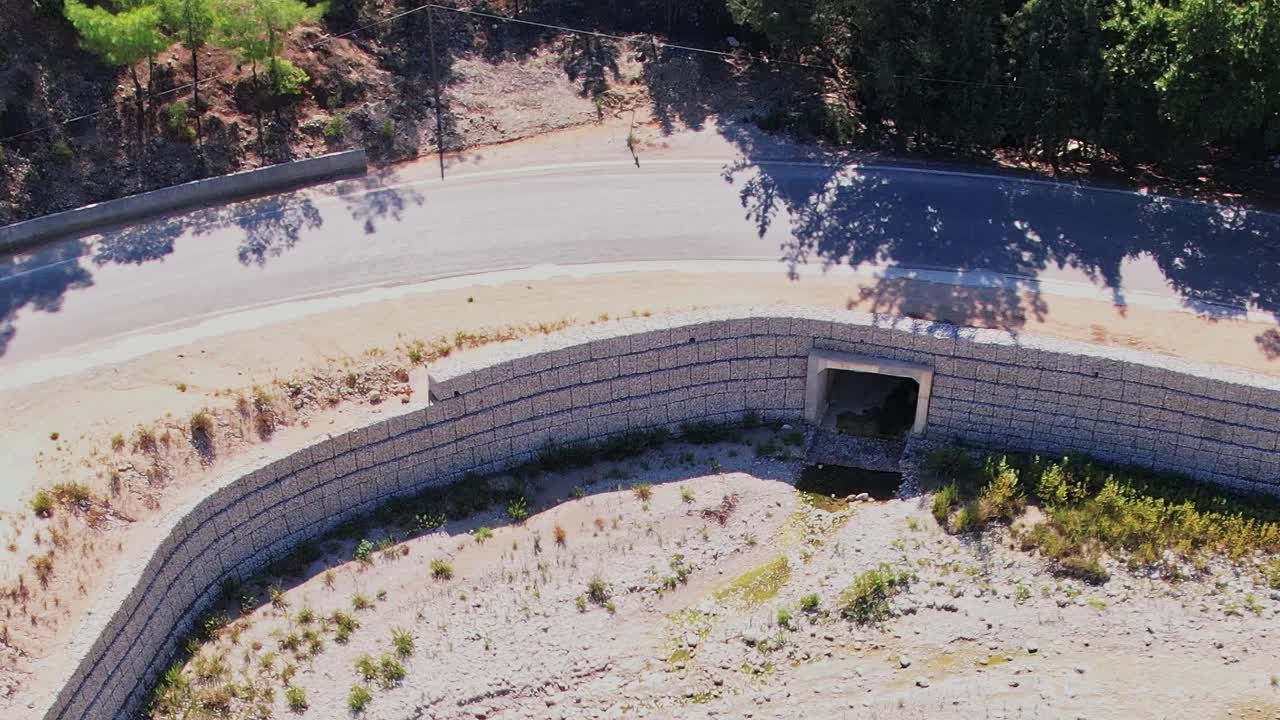 Road near a river tunnel structure in Rhodes, Greece during daylight