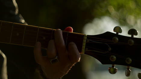 primer plano de una persona tocando una guitarra acústica