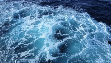 choppy ocean seen from ship with rough waves in open sea, blue water big swell background on a cruise ship boat trip crossing drakes passage to antarctica and antarctic peninsula