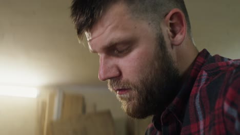 man concentrating on woodworking project