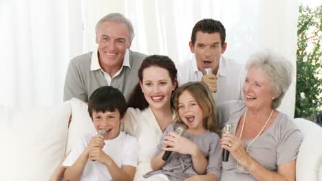 family singing karaoke at home