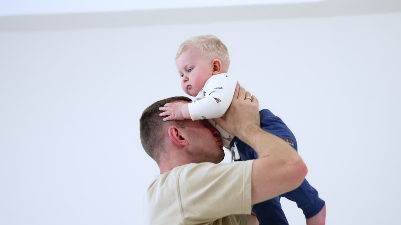 Parenthood lifestyle. Family playing indoor with small cute baby.