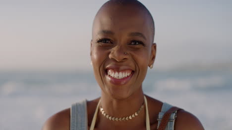 close up portrait of happy african american woman laughing enjoying summer vacation on warm sunny beach background slow motion