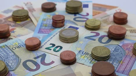 euro banknotes and coins on turntable