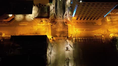 cinematic top-down aerial of a glowing city intersection in downtown youngstown, ohio, with amber lighting and clean grid layout.