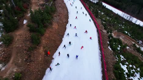 aerial view of skiers and snowboarders go downhill, dolni morava winter event