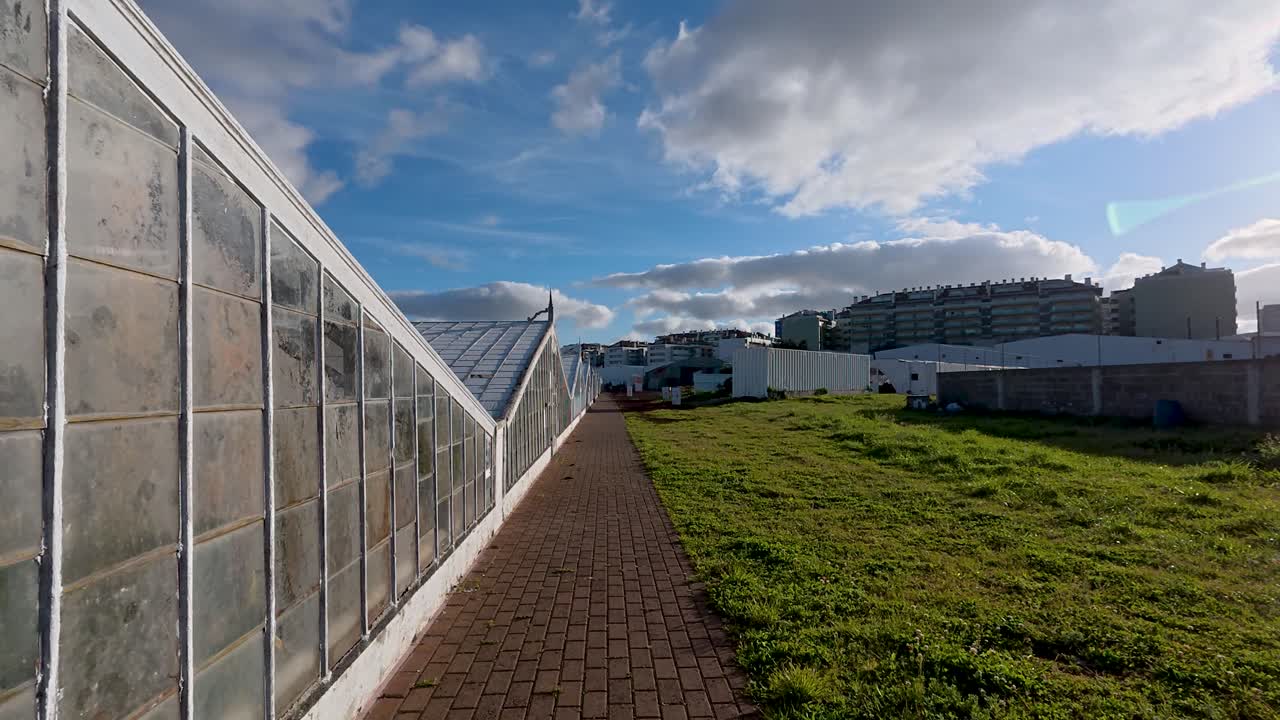 Exterior forward dolly view of big greenhouses in Ponta Delgada, Azores, Portugal