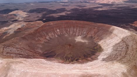 Impressive aerial drone footage of Caldera Blanca, the largest volcanic crater in Lanzarote Measuring approximately 1,200 meters in diameter. Canary Islands, Spain.